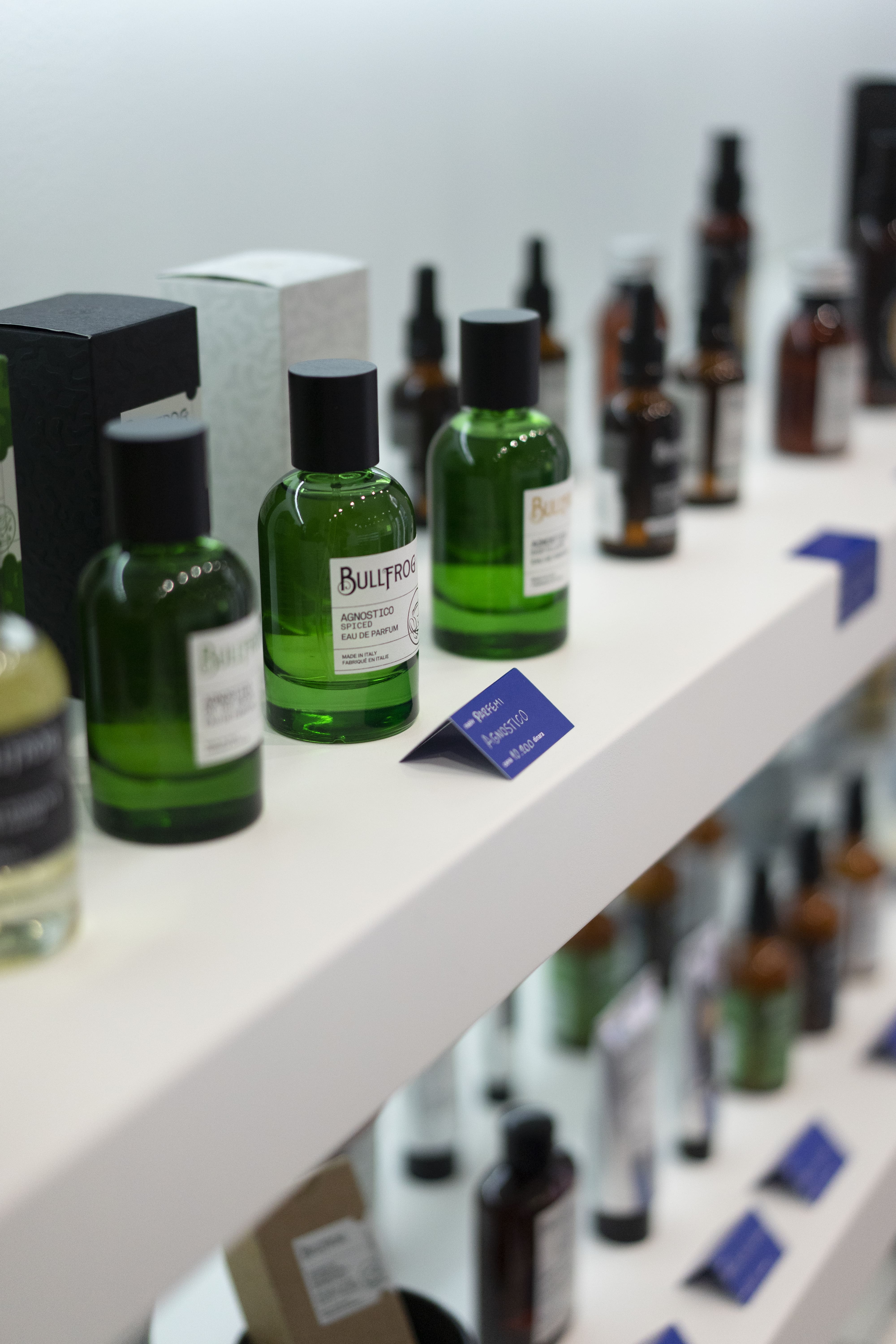 Bullfrog fragrances displayed on the white shelving