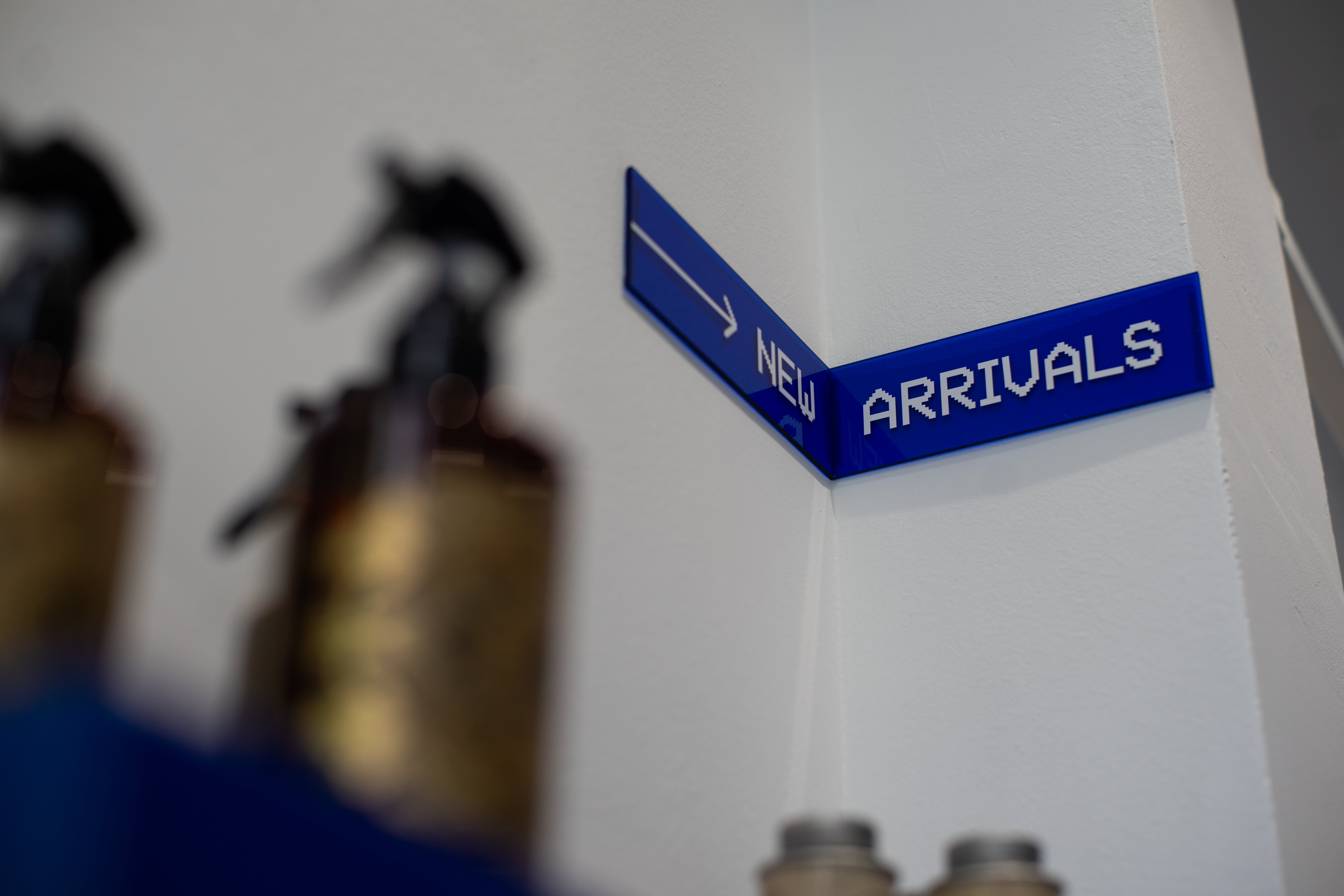 New Arrivals signage wrapping the corner of the shop floor at The Embassy