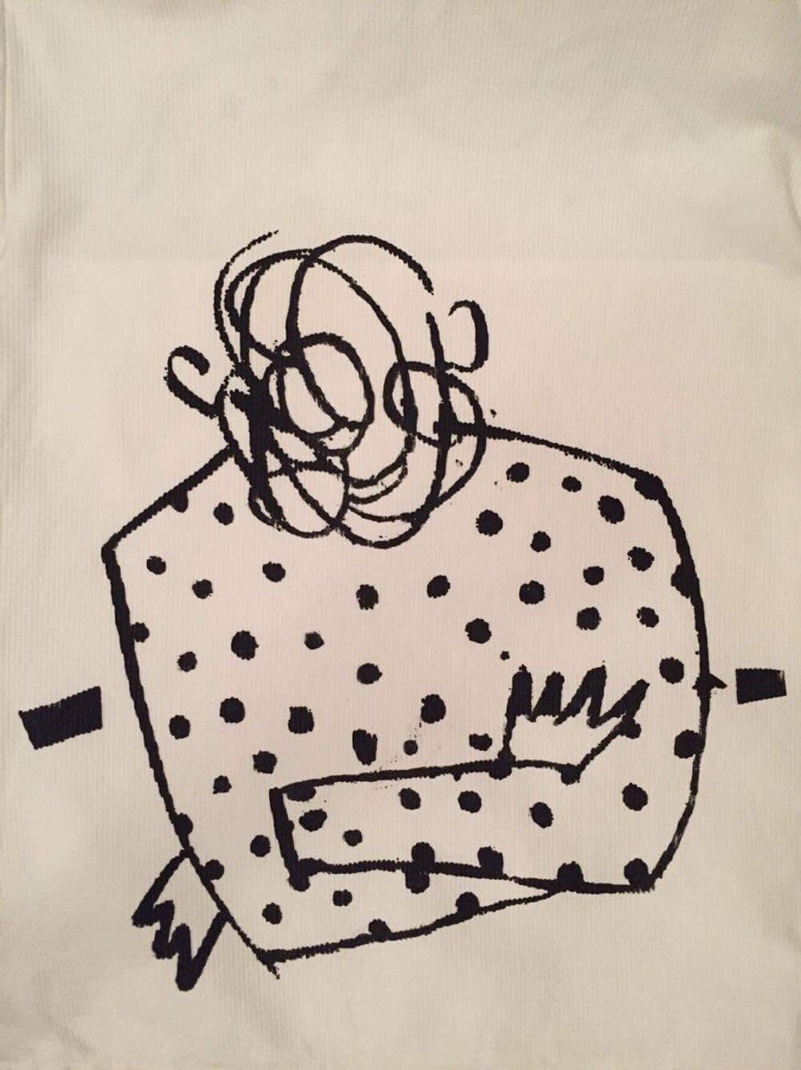 Katarina's illustration screen-printed on fabric — a figure in a polka-dot coat with scribbled hair, arms crossed